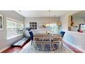 Sunlit dining room featuring hardwood floors and a stylish light fixture at 6313 Woodland Commons Dr, Charlotte, NC 28269
