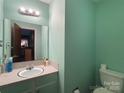Functional bathroom with a single sink vanity, a large mirror, and a neutral color scheme at 6708 Nutcracker Pl, Charlotte, NC 28212
