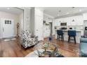 Open concept living space with hardwood floors, modern furnishings, and a view to the kitchen at 7516 O'Hara St, Huntersville, NC 28078