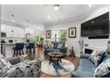 Well-lit living area with an open layout, stylish furniture, and view of the breakfast bar at 7516 O'Hara St, Huntersville, NC 28078