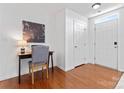 Bright hallway with hardwood floors, a desk, and a white front door at 7612 Turley Ridge Ln, Charlotte, NC 28273