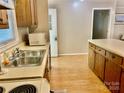 Practical kitchen featuring a double sink, adjacent counters, and wood cabinetry at 1010 Macarthur Rd, Albemarle, NC 28001