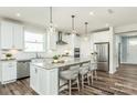 Modern kitchen with white cabinets, marble countertops, stainless steel appliances, and a large island with seating at 1022 Kinship Dr # 118, Lancaster, SC 29720