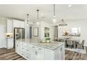 Spacious kitchen featuring a central island with modern pendant lighting and an adjacent dining area at 1022 Kinship Dr # 118, Lancaster, SC 29720