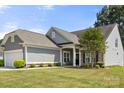 Attractive single-story home with manicured front lawn and stone accents, enhancing its curb appeal at 1031 Fants Grove Ln, Indian Land, SC 29707