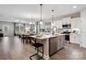 Spacious kitchen with white cabinets, stainless steel appliances, and an island with bar seating at 1045 Mapletree Ln, Indian Trail, NC 28079
