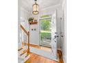 Bright foyer with hardwood floors, white trim, and an open doorway with natural light streaming through at 11126 Windgate Ct, Tega Cay, SC 29708
