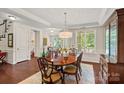 Elegant dining room features a chandelier, a large window, and detailed woodwork at 1209 Shelly Woods Dr, Indian Land, SC 29707