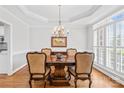 Elegant dining room with a wood table set, chandelier, and natural light from shuttered windows at 132 Broadbill Dr, Mooresville, NC 28117