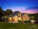 Charming brick home with manicured lawn, mature landscaping, and inviting entrance at 132 Broadbill Dr, Mooresville, NC 28117