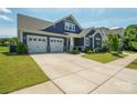 Well-maintained single-story home showcasing a spacious driveway, attached two-car garage, and a lush green lawn at 13339 Mcguffy Dr, Huntersville, NC 28078