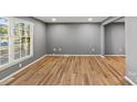 Bright living room with hardwood floors, large windows, and neutral paint at 1510 Sansberry Rd, Charlotte, NC 28262