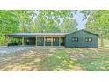 Charming, newly renovated one-story brick home featuring a metal roof and covered carport in a wooded setting at 155 Mcallister Rd, Statesville, NC 28625