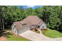 An elevated view of a well-manicured home with a three-car garage, lush landscaping, and a spacious driveway at 1687 Sierra Rd, York, SC 29745