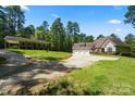 Exterior view of a home with a separate guest house, showcasing the large lot, and ample parking at 1687 Sierra Rd, York, SC 29745