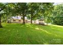 Spacious backyard featuring lush greenery, a detached garage, and a charming gazebo at 2028 Old Latter Rd, Newton, NC 28658