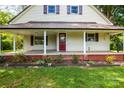 Inviting front porch with brick base, white columns, and a red front door at 2028 Old Latter Rd, Newton, NC 28658