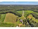 Expansive aerial view of the property, highlighting the home, pool, and surrounding lush greenery at 2145 Jack Wilson Rd, Shelby, NC 28150