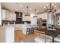 Modern kitchen with stainless steel appliances, white cabinetry, and a breakfast bar at 2195 Millennium Dr # 20, Lancaster, SC 29720