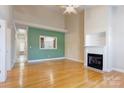 Bright living room with hardwood floors, fireplace, and pass-through to kitchen at 2785 Clover Nw Rd, Concord, NC 28027