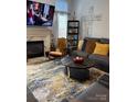 Inviting living room features a fireplace, TV, and comfortable seating arrangement at 4204 Canipe Dr, Charlotte, NC 28269