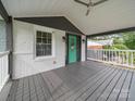 A spacious covered porch with white railings, painted gray floors, and an elegant front door at 430 Edgegreen Dr, Charlotte, NC 28217