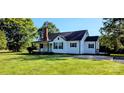 Exterior view of home with green lawn, black shutters, and front porch at 4501 E Highway 27 Hwy, Iron Station, NC 28080