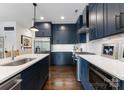 Modern kitchen with navy cabinets, stainless steel appliances, and quartz countertops at 460 E 33Rd St, Charlotte, NC 28205