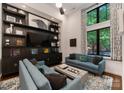 Bright living room featuring custom built-ins, modern decor, and large windows at 460 E 33Rd St, Charlotte, NC 28205