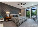 Stylish main bedroom with textured accent wall and abundant natural light at 460 E 33Rd St, Charlotte, NC 28205
