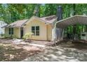 The home's exterior features a carport and nicely landscaped lawn, creating a welcoming curb appeal at 5534 Great Wagon Rd, Charlotte, NC 28215