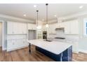 Modern kitchen with large island, stainless steel appliances, and ample cabinet space at 584 Williamson Rd, Mooresville, NC 28117