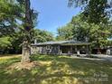 Charming single-story home with a stone front porch and large, shaded front yard at 6616 Love Mill Rd, Monroe, NC 28110