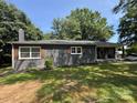 Beautiful brick home with brown shutters and a stone front porch at 6616 Love Mill Rd, Monroe, NC 28110