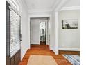 Inviting entryway featuring hardwood floors, white trim, and views of an elegant powder room at 739 Terrace Park, Rock Hill, SC 29730