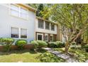 Traditional multi-level home showcasing manicured landscaping and a classic front entrance at 8266 Knights Bridge Rd, Charlotte, NC 28210