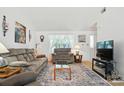 Comfortable living room with cozy seating, natural light, and a decorative area rug at 8529 Indian Summer Trl, Harrisburg, NC 28075