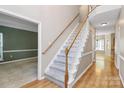 Elegant entryway with a staircase, hardwood flooring, and open access to other rooms at 11305 Hunters Landing Dr, Charlotte, NC 28273
