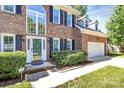 Close-up shot of the home's entryway shows a beautiful glass front door and manicured landscaping at 11305 Hunters Landing Dr, Charlotte, NC 28273