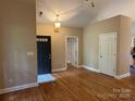 Inviting foyer features hardwood floors, neutral walls, and a classic chandelier providing a warm welcome at 13221 Brandywine Ln, Midland, NC 28107