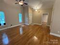 Bright living room boasts gleaming hardwood floors, vaulted ceilings, and lots of natural light from large windows at 13221 Brandywine Ln, Midland, NC 28107