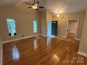 This living room features hardwood floors, vaulted ceilings, and natural light creating a spacious feel at 13221 Brandywine Ln, Midland, NC 28107