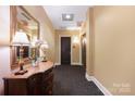 Neutral hallway featuring a decorative dresser and lamps that adds style and illumination to the space at 229 N Church St # 100, Charlotte, NC 28202