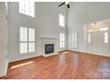 Open living space with fireplace, high ceilings and large windows, seamlessly blends comfort and style at 2830 Grosbeak Ln, Charlotte, NC 28269
