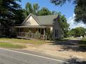 A well-maintained single-story home with a quaint front porch and lush green surroundings at 2944 N Lookout St, Claremont, NC 28610