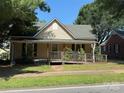 Inviting single-story home featuring a front porch and convenient wheelchair ramp access at 2944 N Lookout St, Claremont, NC 28610