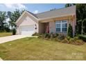 Charming one-story home with a well-manicured lawn and brick facade, creating curb appeal at 3006 Constitution Ln, Gastonia, NC 28056