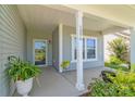 Inviting front porch with white pillars, plants, and visible house number at 3296 Saddlebrook Dr, Midland, NC 28107