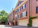 Beautiful brick townhome with attached garage, black shutters, and meticulously kept landscaping at 344 S Laurel Ave, Charlotte, NC 28207