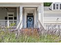 Inviting front porch entrance with well-maintained stairs, decorative wreath, and vibrant landscaping at 3535 Selwyn Farms Ln, Charlotte, NC 28209